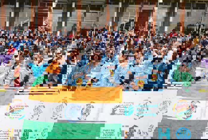 Team celebrating behind the flag of India after winning the Street Child Cricket World Cup at Lord's.