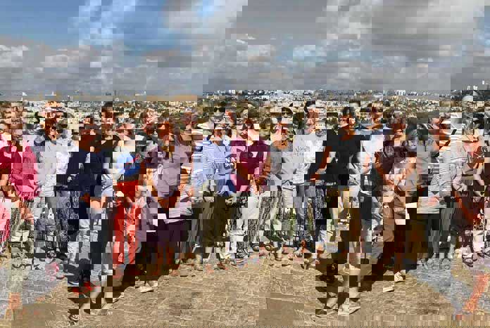 A group of women from the UK standing at the top of the Mount of Olives over-looking the Old City of Jerusalem.