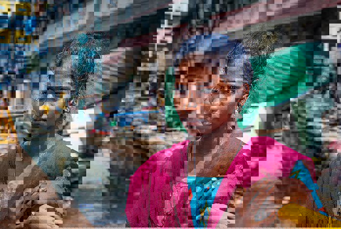 A young Indian women looking into the distance on a street in India.